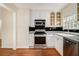 Kitchen features stainless steel appliances, black tile backsplash, and wood floors at 961 Lindbergh Ne Dr, Atlanta, GA 30324