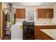 Functional laundry area features washer, dryer, water heater, cabinets, and tiled counter space at 961 Lindbergh Ne Dr, Atlanta, GA 30324