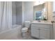 Bright bathroom featuring a shower-tub combo with gray tile and a white vanity at 209 Snapdragon St, Woodstock, GA 30188