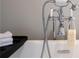Close-up of a luxurious white bathtub with modern fixtures and a hand-held shower at 209 Snapdragon St, Woodstock, GA 30188