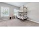 Cozy bedroom featuring a bunk bed, neutral tones, and natural light from the window at 209 Snapdragon St, Woodstock, GA 30188