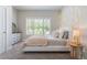 Serene bedroom featuring a plush bed, soft lighting, and a picturesque window view, creating a relaxing retreat at 209 Snapdragon St, Woodstock, GA 30188