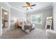 Comfortable bedroom with a ceiling fan, plush carpet, and a window with natural light at 209 Snapdragon St, Woodstock, GA 30188