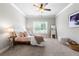 Cozy bedroom with a ceiling fan, plush carpet, and a window with natural light at 209 Snapdragon St, Woodstock, GA 30188