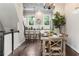 Elegant dining area adjacent to the kitchen, featuring a stylish chandelier and ample seating at 209 Snapdragon St, Woodstock, GA 30188