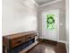 Inviting foyer with dark hardwood floors, complemented by a stylish console table and a wreath on the front door at 209 Snapdragon St, Woodstock, GA 30188