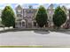 Attractive multi-story townhomes with brick and siding and professionally landscaped front yards, exuding curb appeal at 209 Snapdragon St, Woodstock, GA 30188