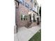 Elegant brick facade with covered entry, enhancing the curb appeal of this meticulously maintained townhome at 209 Snapdragon St, Woodstock, GA 30188