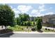 Community green space featuring landscaping, trees, benches, and adjacent residential buildings at 209 Snapdragon St, Woodstock, GA 30188