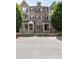 Attractive multi-story townhomes with brick and siding and professionally landscaped front yards, exuding curb appeal at 209 Snapdragon St, Woodstock, GA 30188