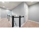 Bright upstairs hallway with staircase and neutral color palette offering access to several rooms at 209 Snapdragon St, Woodstock, GA 30188