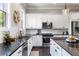 Updated kitchen features sleek countertops, stainless steel appliances, and ample cabinet space at 209 Snapdragon St, Woodstock, GA 30188