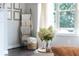Cozy interior featuring a ladder with blankets, a crystal vase with hydrangeas, and natural light at 209 Snapdragon St, Woodstock, GA 30188
