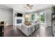 Bright living room featuring a fireplace, ceiling fan, and access to an outdoor balcony at 209 Snapdragon St, Woodstock, GA 30188