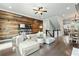 Inviting interior with a wood accent wall, hardwood floors, and a view of the staircase and dining area at 209 Snapdragon St, Woodstock, GA 30188