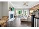 Inviting living room with fireplace, wood accent wall, and abundant natural light, perfect for relaxation and entertainment at 209 Snapdragon St, Woodstock, GA 30188