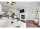 Open-concept living area showcasing a fireplace, hardwood floors, and seamless flow to other living spaces at 209 Snapdragon St, Woodstock, GA 30188