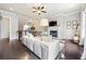 Spacious living room with hardwood floors, fireplace, and open concept design leading to the dining area at 209 Snapdragon St, Woodstock, GA 30188