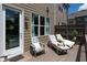 Cozy outdoor patio with lounge chairs, perfect for relaxation and enjoying the sunshine at 209 Snapdragon St, Woodstock, GA 30188