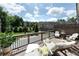 Relaxing covered patio with comfortable seating, strung lights, and views of the community at 209 Snapdragon St, Woodstock, GA 30188