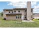 Home exterior featuring a patio, chimney, and large windows overlooking the yard at 250 Kensington Trce, Stockbridge, GA 30281