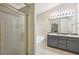 A full bathroom with a shower stall and vanity with double sinks and granite counters at 250 Kensington Trce, Stockbridge, GA 30281