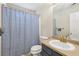 Bathroom featuring a shower-tub combo with a blue-patterned curtain and a vanity sink at 250 Kensington Trce, Stockbridge, GA 30281