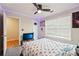 This bedroom includes a ceiling fan, and a window with natural light at 250 Kensington Trce, Stockbridge, GA 30281