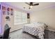 This bedroom includes a ceiling fan, a window, and sports-themed decor at 250 Kensington Trce, Stockbridge, GA 30281