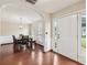 Inviting dining room with hardwood floors, wainscoting, and archway with exterior view through front door at 250 Kensington Trce, Stockbridge, GA 30281