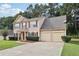 Attractive two-story house with a two-car garage, manicured lawn, and brick accents enhance curb appeal at 250 Kensington Trce, Stockbridge, GA 30281
