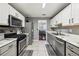 Well-lit kitchen with stainless steel appliances and gray cabinets at 250 Kensington Trce, Stockbridge, GA 30281