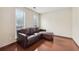 Relaxing living area featuring hardwood floors, and a comfortable leather sectional couch with natural light at 250 Kensington Trce, Stockbridge, GA 30281
