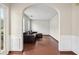 Arched doorway leads to a cozy living room with hardwood floors and a comfortable leather sofa at 250 Kensington Trce, Stockbridge, GA 30281