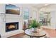 The fireplace in the living room has a burning fire at 250 Kensington Trce, Stockbridge, GA 30281