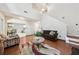 Open concept living room with fireplace, stairs, and access to the dining area at 250 Kensington Trce, Stockbridge, GA 30281