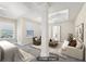 Spacious staged main bedroom with sitting area, tray ceiling and neutral decor at 250 Kensington Trce, Stockbridge, GA 30281