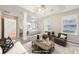 Spacious staged main bedroom with sitting area, tray ceiling, and ensuite access at 250 Kensington Trce, Stockbridge, GA 30281
