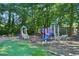 Community playground with swings, slides and spring toys in a grassy area at 250 Kensington Trce, Stockbridge, GA 30281