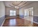 Elegant dining room with tray ceiling, chandelier, and chair rail trim at 2500 Rosehill Cir, Lithia Springs, GA 30122