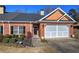 Charming brick home with manicured lawn, two-car garage, and ADT security system at 2500 Rosehill Cir, Lithia Springs, GA 30122