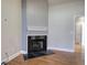 Living area with a black marble fireplace and wood laminate flooring at 2500 Rosehill Cir, Lithia Springs, GA 30122