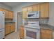 Well-lit kitchen features stainless steel appliances, tile floor, and light wood cabinetry at 2500 Rosehill Cir, Lithia Springs, GA 30122