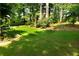 Expansive backyard with lush green lawn, mature trees, and a charming gazebo, creating a serene and private outdoor space at 2720 Stillwater Lake Ln, Marietta, GA 30066