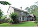 Expansive home backyard features a well-manicured lawn, mature trees, and a charming covered patio area at 2720 Stillwater Lake Ln, Marietta, GA 30066