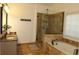 Elegant bathroom with a double vanity, a luxurious soaking tub, and a separate glass-enclosed shower, creating a spa-like experience at 2720 Stillwater Lake Ln, Marietta, GA 30066