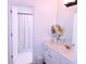 Clean, bright bathroom featuring a white vanity, decorative flowers, a large mirror, and a shower with a curtain at 2720 Stillwater Lake Ln, Marietta, GA 30066