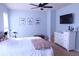 Neutral colored bedroom offering a ceiling fan, playful decor, natural light, and comfortable living space at 2720 Stillwater Lake Ln, Marietta, GA 30066