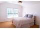 Bright bedroom with white walls, plush carpet, a large window, and a comfortable queen sized bed at 2720 Stillwater Lake Ln, Marietta, GA 30066