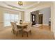 Formal dining room with modern lighting and a large window, perfect for Gathering gatherings and entertaining guests at 2720 Stillwater Lake Ln, Marietta, GA 30066